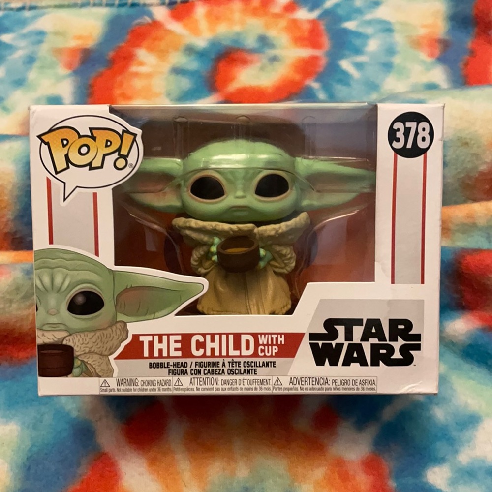Never opened funko POP child with cup